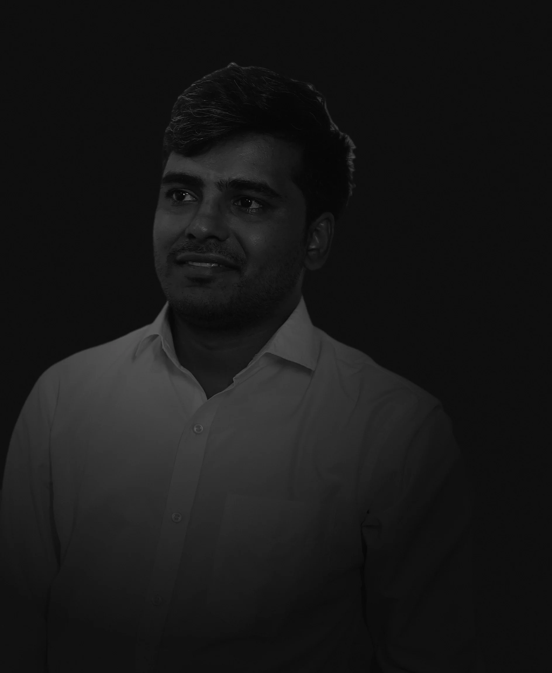 Black-and-white low-light portrait of Divyesh Ghediya